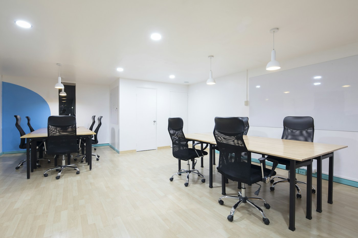 A bright office with organized desks and welcoming shared space